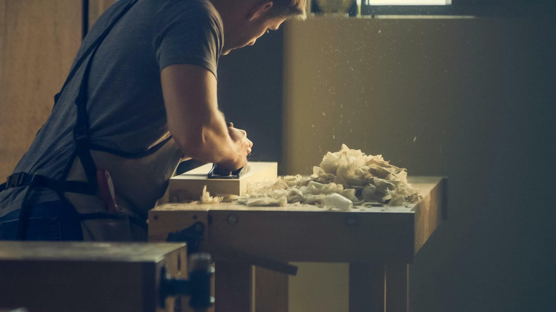 Sean Mullan planing timber in the workshop